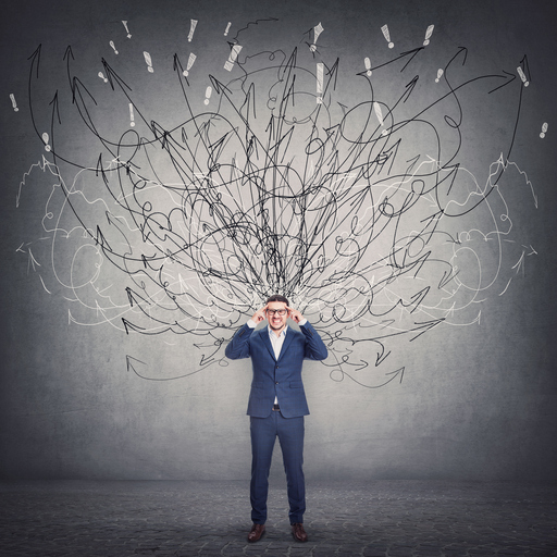 Frustrated man with lots of tangled lines coming out of his head